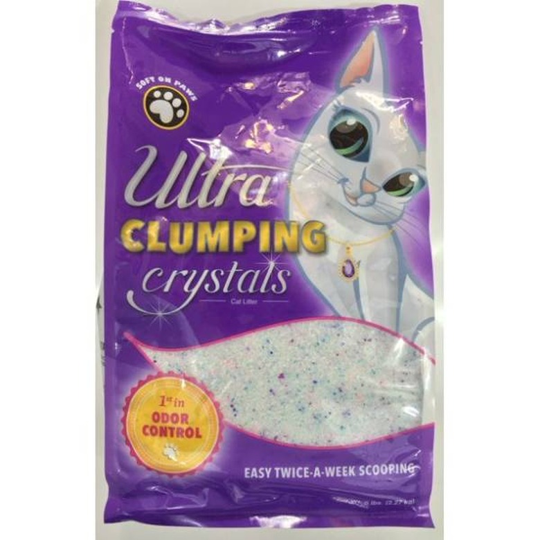 A 5-pound bag of Ultra Clumping Odor Control Low Dust Crystal Cat Litter against a white background. The bag is purple with a cartoon white cat on it. A badge on the bag says 1st in odor control.