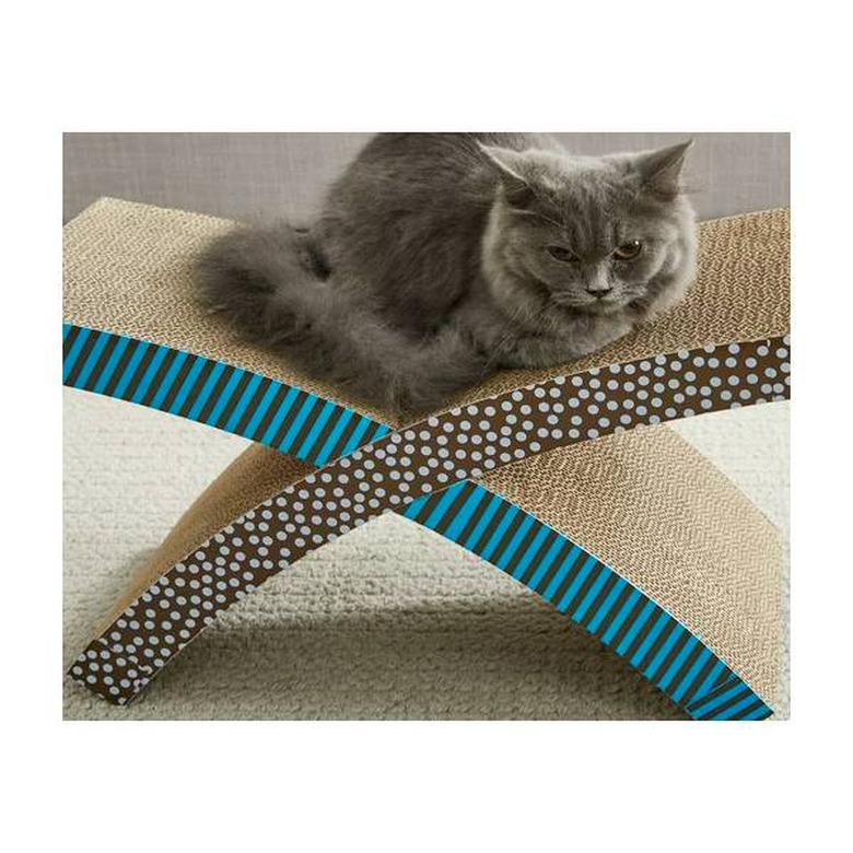 A grey cat resting on a Petstages Scratch 'n Rest Cat Scratcher
