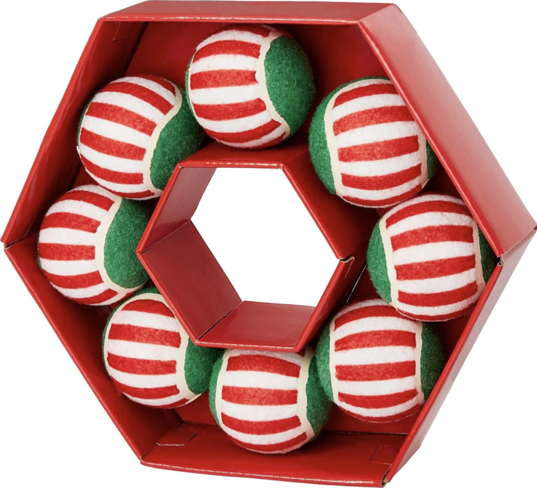 Wreath-shaped red box with 8 striped tennis balls inside that are red