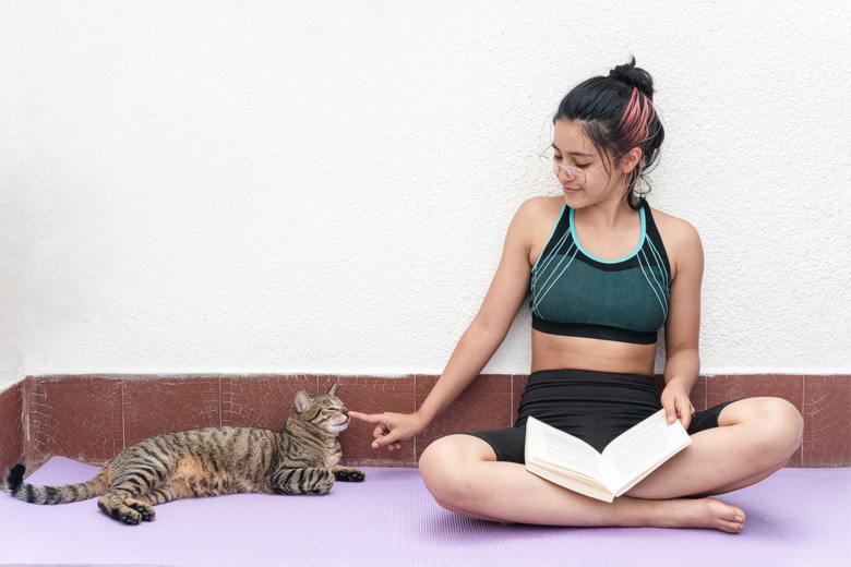 Girl reading a book next to her pet. Love for reading
