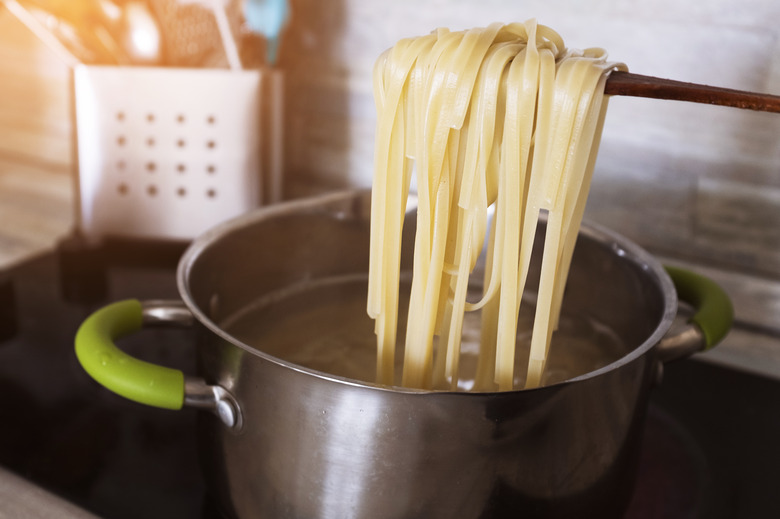 Cooking pasta at home in a pan. Spaghetti