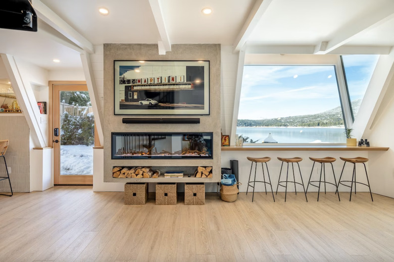 Living room with expansive windows with lake views