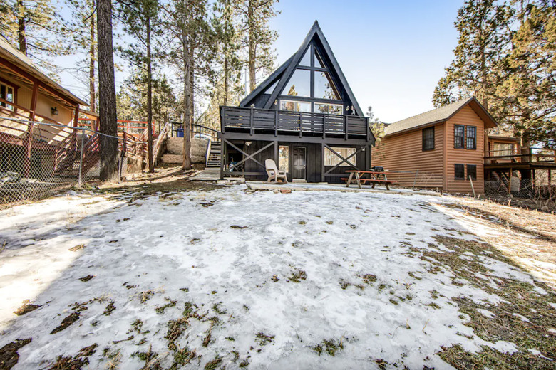 Black A-frame shown from the large backyard