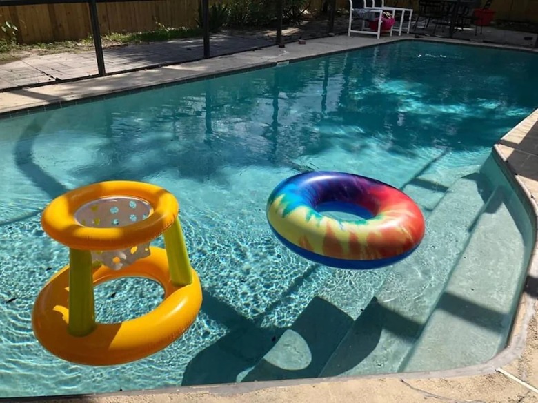 Swimming pool with floating inner tube and pool toy in Orlando