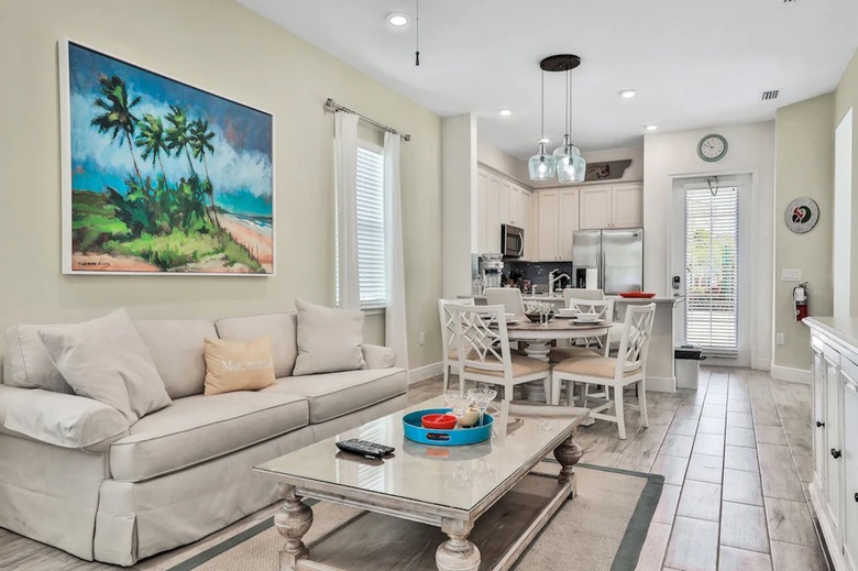 Bright and airy great room with sofa and dining in Florida vacation home.