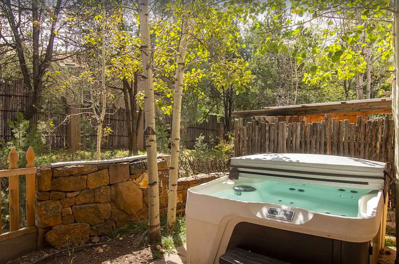 A hot tub nestled among Aspen trees in Santa Fe