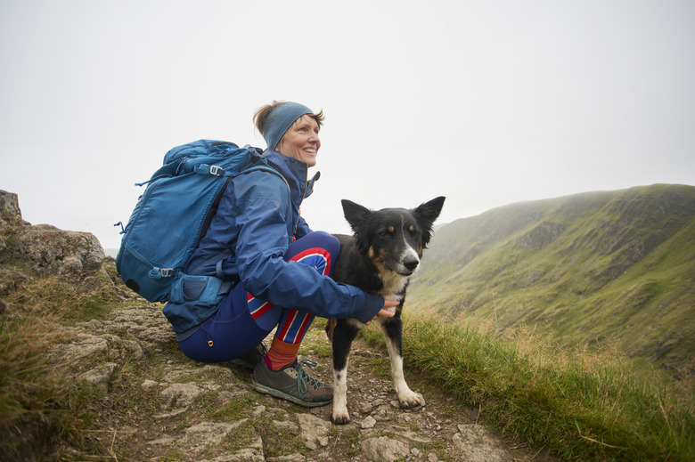 Lone female and her dog in rugged terrain