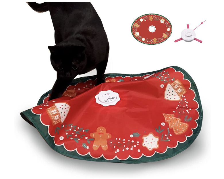 Mouse under blanket cat toy that looks like a Christmas tree skirt and has gingerbread men
