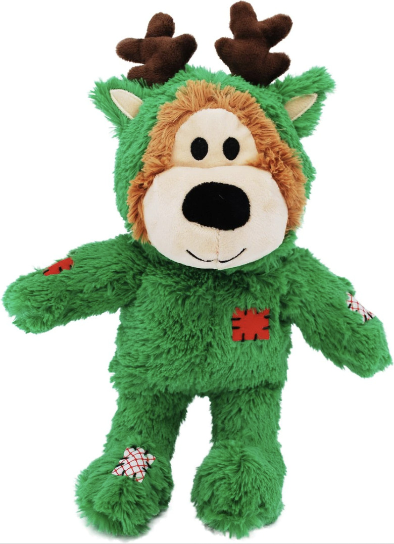 Plush KONG dog toy shaped like a green bear with antlers and red and white patches.