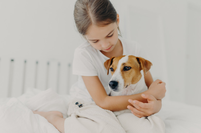 Cropped image of caring little girl in white t shirt