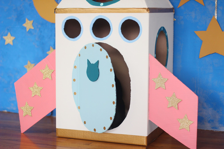 Gold stars on wings and cat head silhouette on door