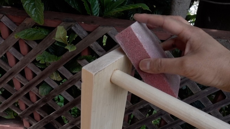 Sanding DIY dog puzzle feeder.