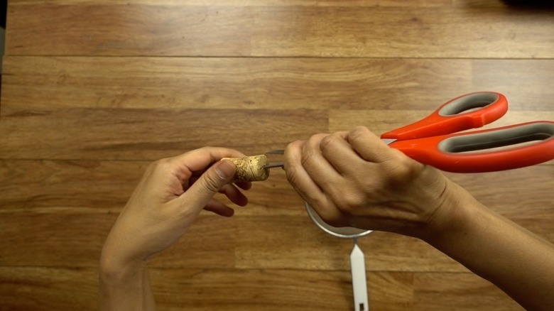 Boring holes into corks for DIY cat toys out of wine corks.