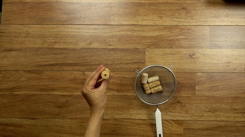 Boring holes into corks for DIY cat toys out of wine corks.