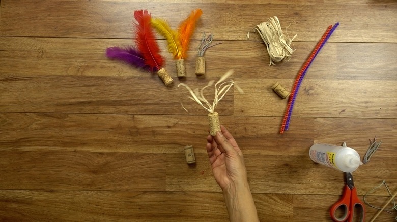 Tassel toy made from raffia and wine cork.