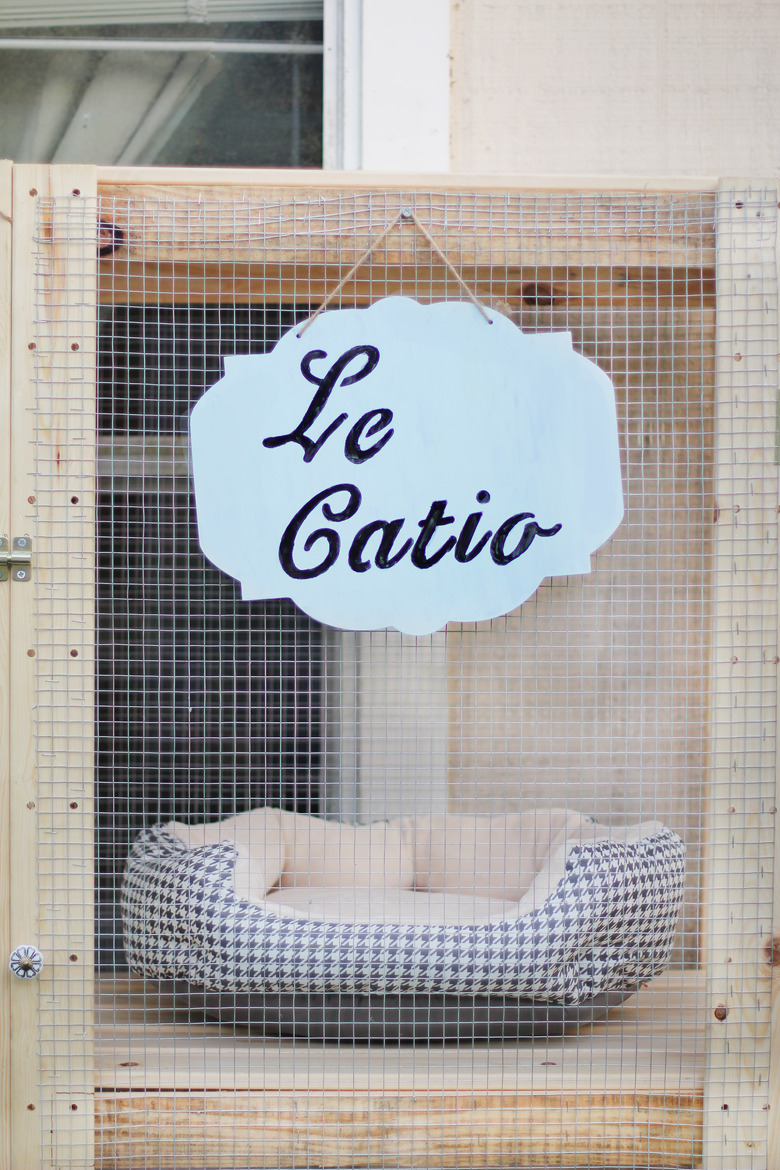 Le Catio sign hanging on front of catio