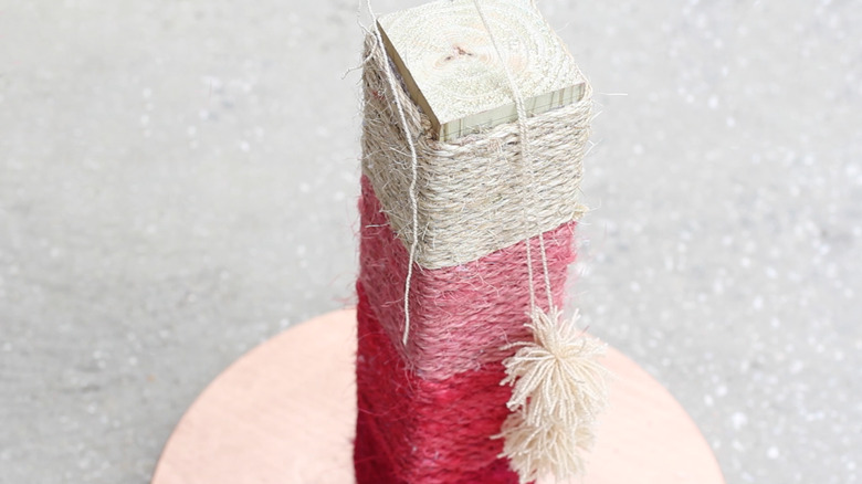 attaching pom-poms to scratching post