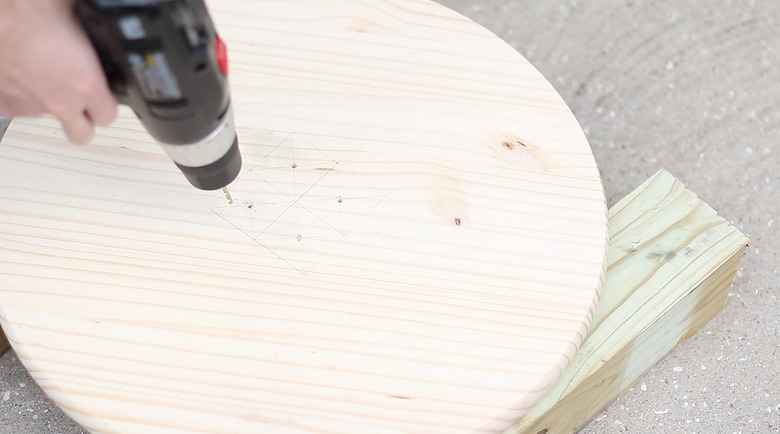drilling pilot holes into wood circle
