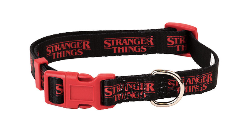 Stranger Things collar against a white background. The collar is black with red logos printed on it