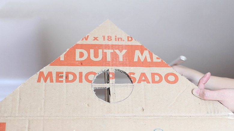 cutting decorative window out on box