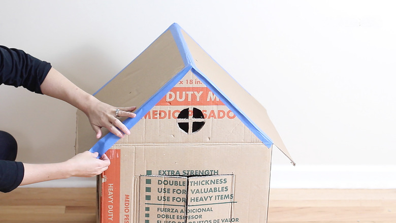 taping roof onto house