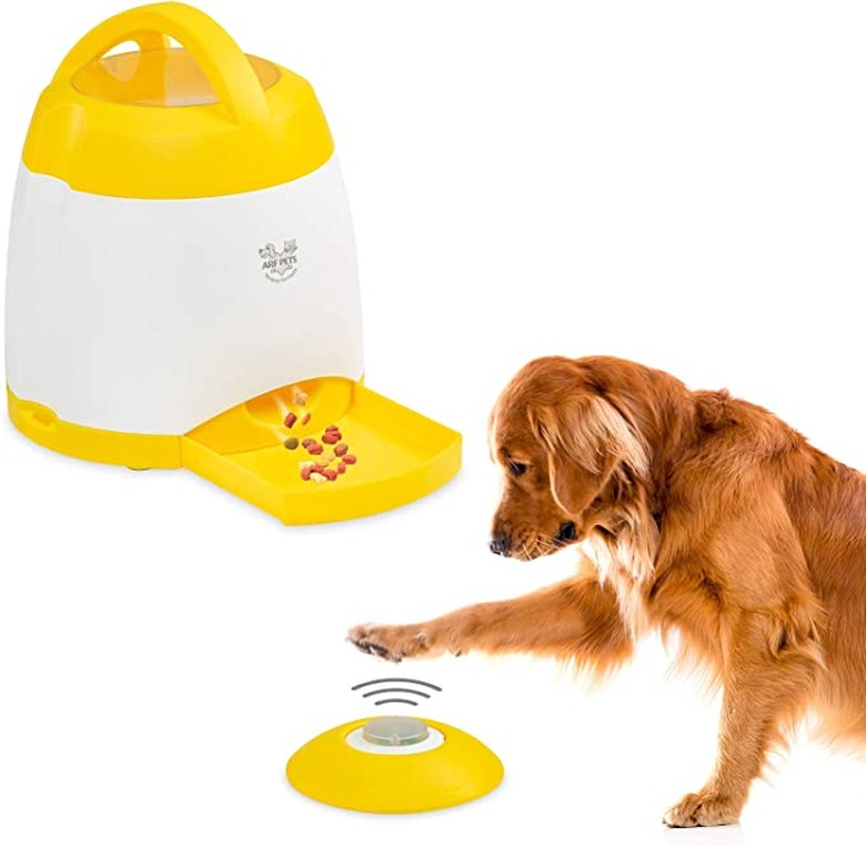 Dog hitting treat dispenser button next to enlarged photo of treat dispenser
