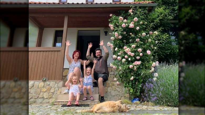 A family buys a home and feeds the local cat.