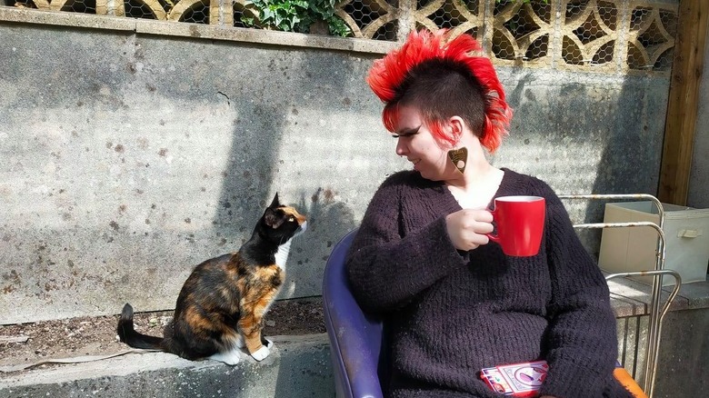 cat stares at woman with mohawk