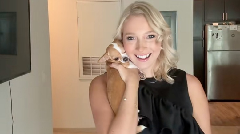 A woman holding her 3-year-old Chihuahua named Blondie