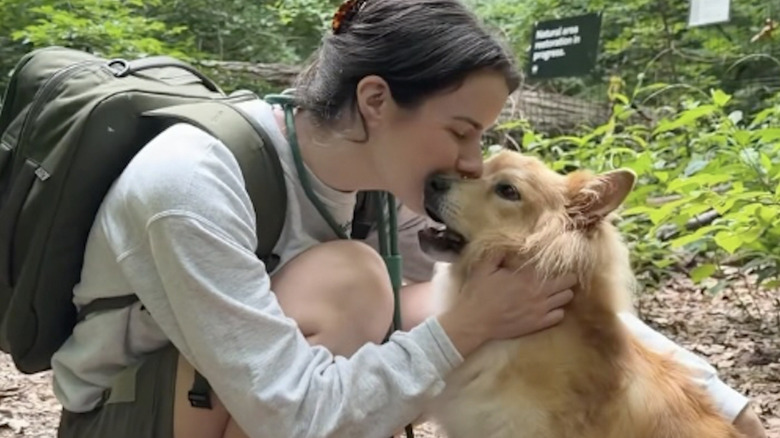 Isabel Klee and her dog Simon share a sweet kiss on a hike.