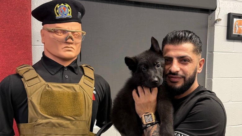 Man posing with puppy