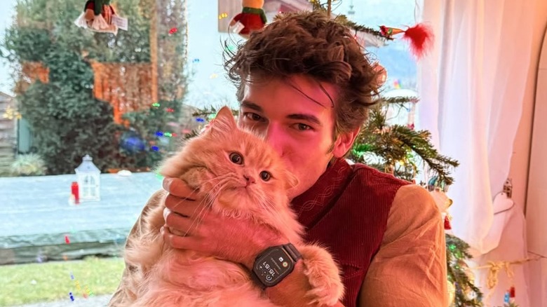 Man kissing his ginger cat