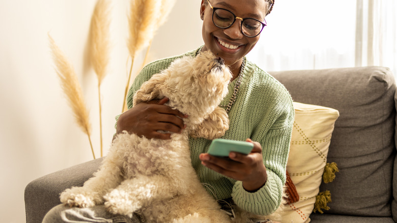A dog gives a woman a kiss.