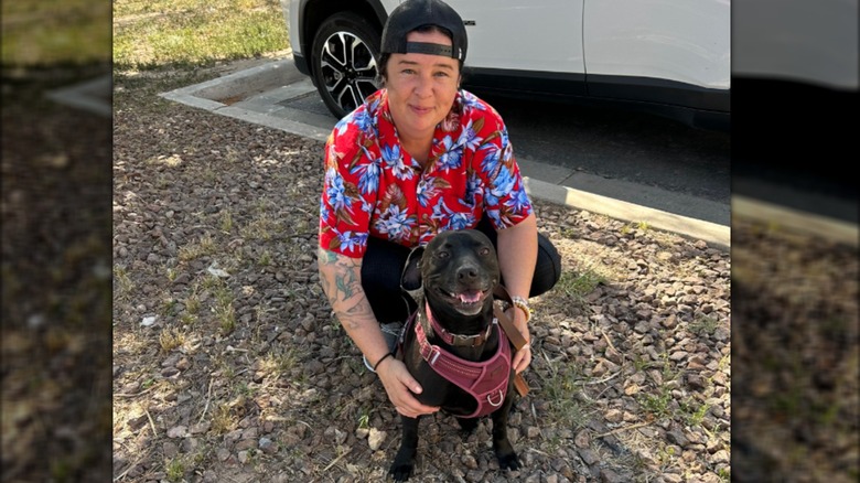 Happy Labrador-pit bull mix posing with adopter