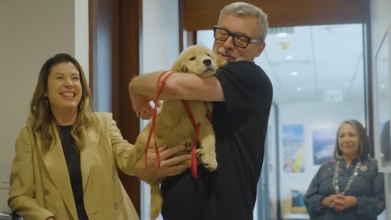 A man holding Sailor the golden retriever